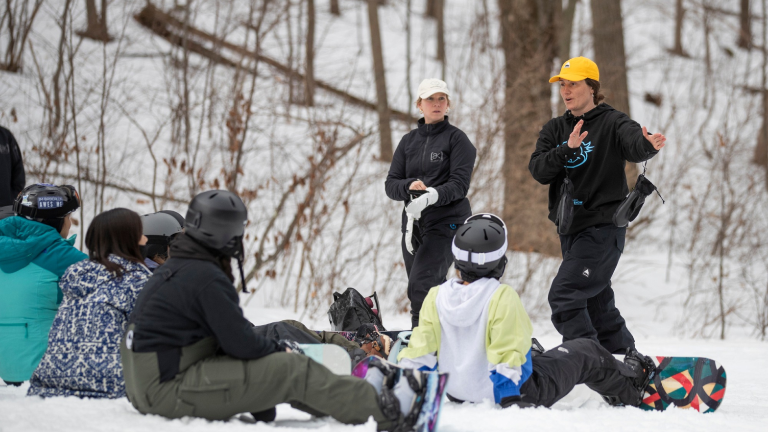 Beyond the Boundaries instructors teaching a group of women how to snowboard at Mountain Creek in Vernon, New Jersey.